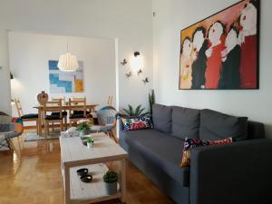 a living room with a couch and a table at Spacious 110m2 2bedrooms 2bathrooms Center Athens in Athens