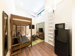 a room with a bunk bed and a television at TRIP POD SUMIYOSHI A in Fukuoka