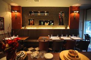 a dining room with tables and chairs in a restaurant at Hotel Quest Shimizu in Shizuoka