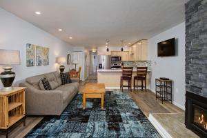 a living room with a couch and a fireplace at Timber Ridge Unit 2E Condo in Aspen