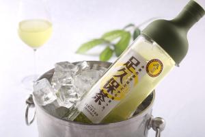 a bottle of wine in a bucket of ice at Hotel Quest Shimizu in Shizuoka