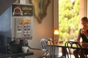 a coffee machine sitting on a table in a restaurant at Hotel Quest Shimizu in Shizuoka