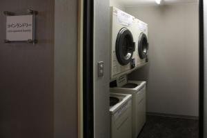 a washer and dryer in a small room at Hotel Quest Shimizu in Shizuoka