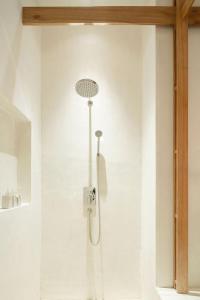 a shower in a bathroom with a shower head at Sala Ayutthaya in Phra Nakhon Si Ayutthaya