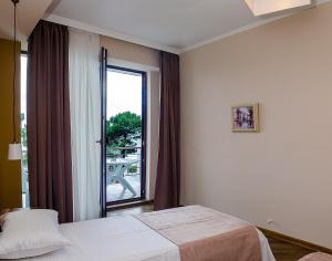 a hotel room with a bed and a window at Resolute Shekvetili Hotel in Shekhvetili +48 photos