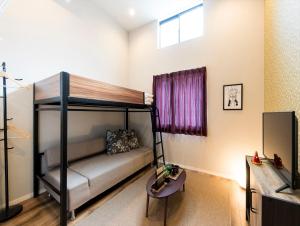 a room with a bunk bed and a table at TRIP POD CHIYO A in Fukuoka