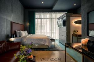 a hotel room with a bed and a window at HOTEL le JARDIN SECRET saigon in Ho Chi Minh City