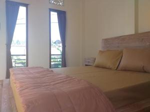 Postel nebo postele na pokoji v ubytování Yuda Homestay