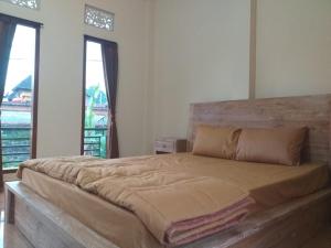 Postel nebo postele na pokoji v ubytování Yuda Homestay + 3 fotografie