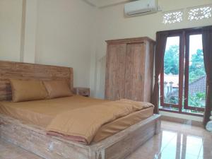 Postel nebo postele na pokoji v ubytování Yuda Homestay