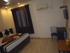 Cama ou camas em um quarto em Hotel Abhineet Palace