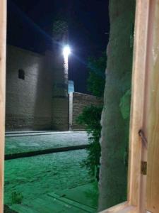 a view of a street at night with a light at Khiva Mirza Bobur Guest House in Khiva