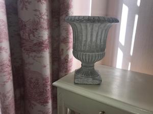 a vase sitting on top of a table at Hôtel Les Deux Magots in La Roche-Bernard