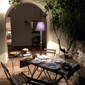 a table with two chairs and a table with food on it at Can Giribets in Argelaguer