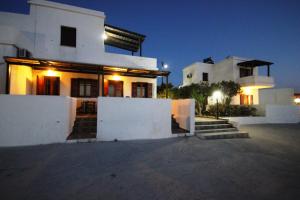 a large white house at night with lights at Galini in Agia Irini Milos