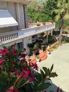 a balcony of a house with flowers and plants at B&B Primerano SP73 in Soriano Calabro