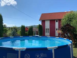 a large swimming pool in the yard of a house at Pensiunea Robi&Norbi Sovata in Sovata