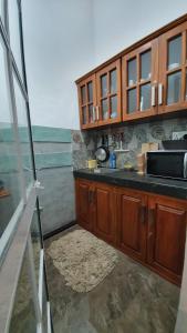 a kitchen with wooden cabinets and a counter top at Thara Cabana in Bentota +138 photos