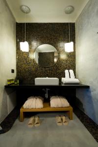 a bathroom with a sink and a mirror at Avaton Resort And Spa in Imerovigli