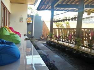 a room with potted plants on a patio at Backpackers Home Amed in Amed