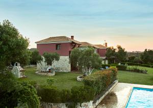 a house with a garden and a swimming pool at Rastoni Fabienne Shared Pool Maisonette, Afitos in Afitos