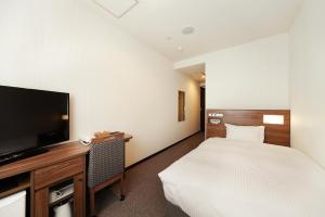 Tempat tidur dalam kamar di Toho Hotel Namba Motomachi