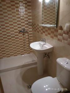 a bathroom with a sink and a toilet at Ermones Mare in Ermones