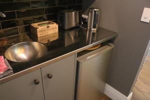 a kitchen counter with a sink and a box on it at Luxurious Escape,Matakana in Matakana