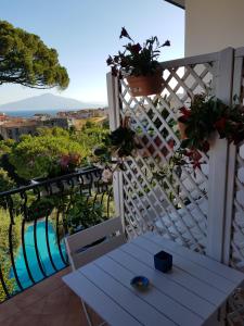 a white balcony with a bench and a view at BLU SEA SORRENTO in Sorrento