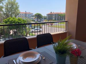a table on a balcony with a view of a street at Stella Marina in Grado