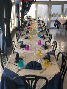 a row of long tables with wine glasses and napkins at Villa Adele Ponza in Ponza