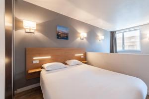 
a hotel room with a bed and two lamps at Residhotel Le Grand Prado in Marseille
