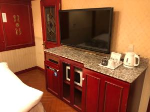 a room with a flat screen tv in a hotel room at Restay Puchi Nagasaki Club (Adult Only) in Nagasaki