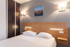 Ένα ή περισσότερα κρεβάτια σε δωμάτιο στο Residhotel Le Grand Prado