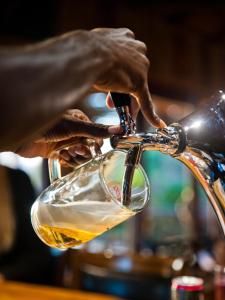 a person pouring wine into a wine glass at Omarunga Epupa-Falls Camp in Epupa