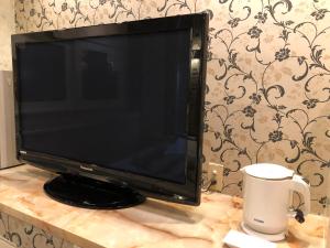 a flat screen tv sitting on top of a table at Restay Nagasaki Aine (Adult Only) in Nagasaki