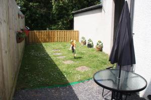 a child running through a yard in a backyard at Ortari@70 in Bishopston