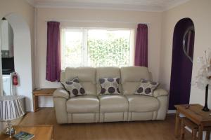 a living room with a couch and a window at Ortari@70 in Bishopston