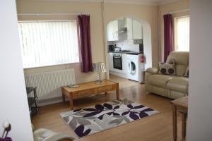 a living room with a couch and a table at Ortari@70 in Bishopston