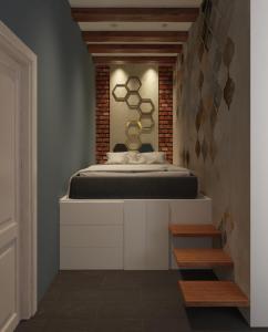 a bedroom with a bed and a brick wall at Dimora Frattina in Rome