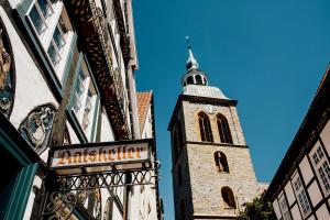 a building with a tower with a clock on it at Ratskeller Wiedenbrück in Rheda-Wiedenbrück