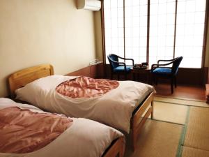 Postel nebo postele na pokoji v ubytování Hotel New Ohruri