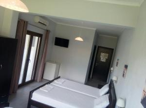 a room with a bed and a large mirror at Tsanis in Parga