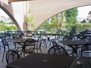 a group of tables and chairs in a patio at Ariete in Ponsacco