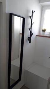 a mirror on a white wall next to a window at Apartment Adriatic in Makarska +5 photos