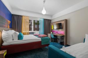 Un pat sau paturi într-o cameră la ProfilHotels Richmond