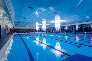 a large swimming pool with lights on the ceiling at ECO Therma Village - All Inclusive, Beach and Mini Aquapark in Kranevo