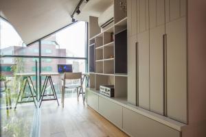 a kitchen with a desk and a table with a chair at Penthouse in the City Center in Vilnius