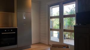 uma cozinha com uma porta de vidro deslizante para uma varanda em Le Clos des Bories em Sarlat-la-Canéda