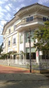 a white house with a white fence in front of it at Daffodils Spice Court in Cochin